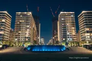 Harumi tower apartment complex and blue-lit fountain pond